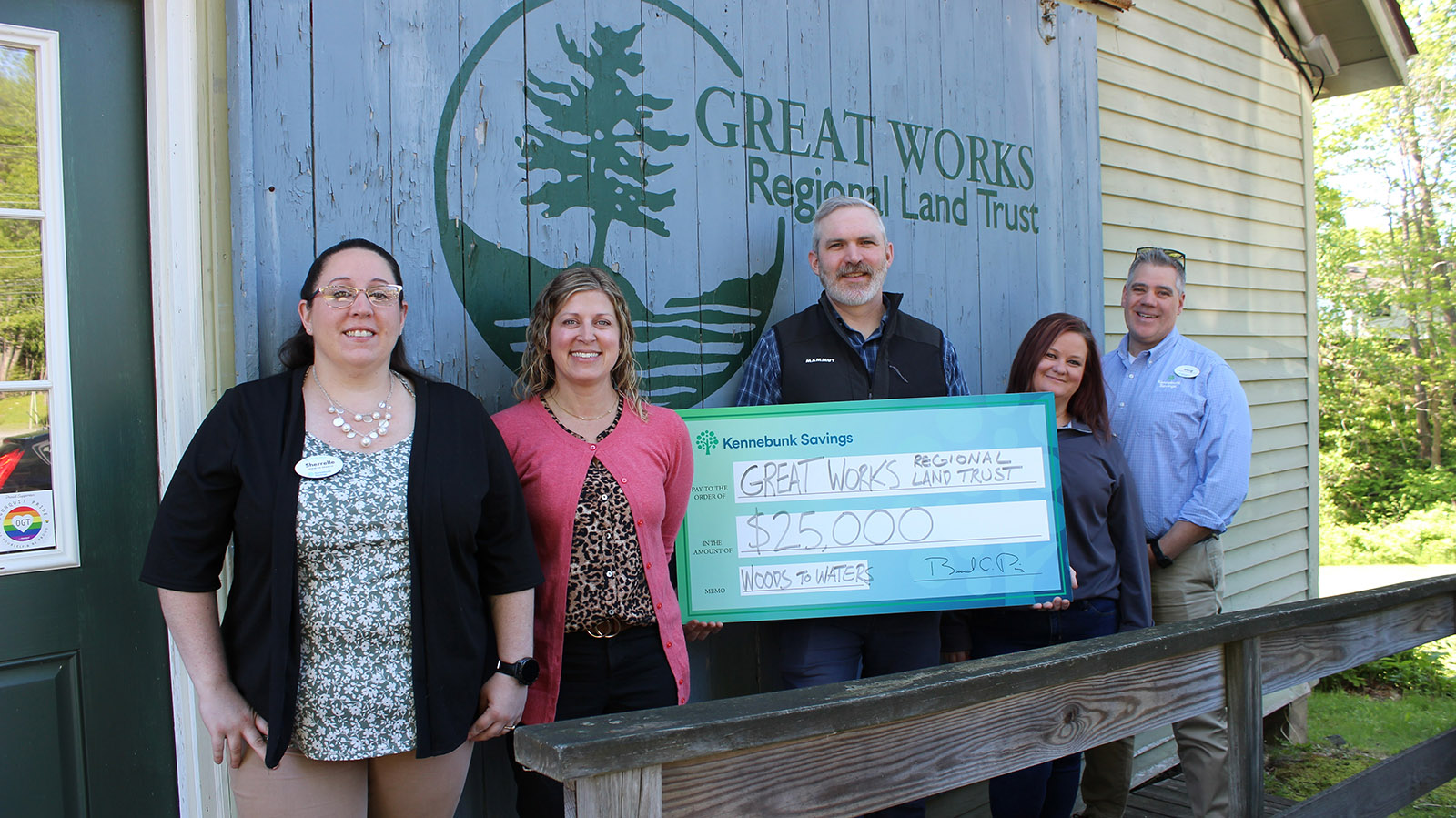 Employees of Kennebunk Savings pose GWRLT Director Jordan Kelley