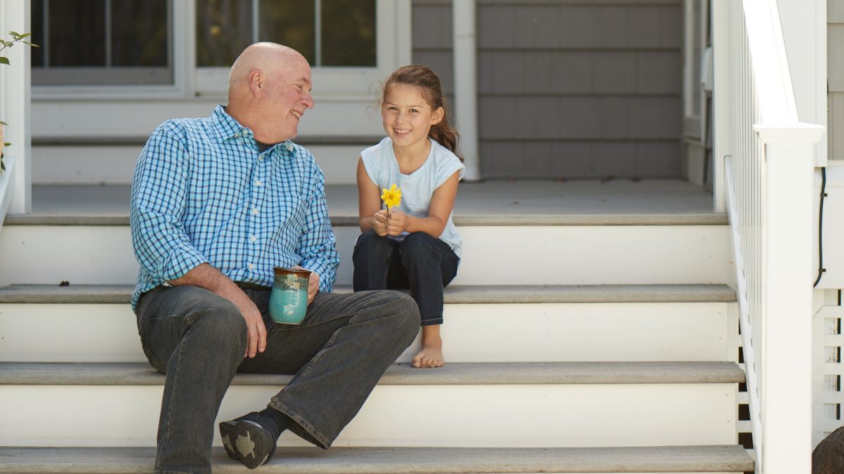 man and young girl on porch