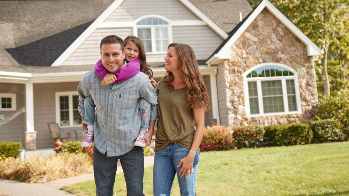 couple in front of house