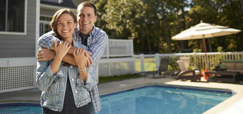 Woman and man standing in front of home pool