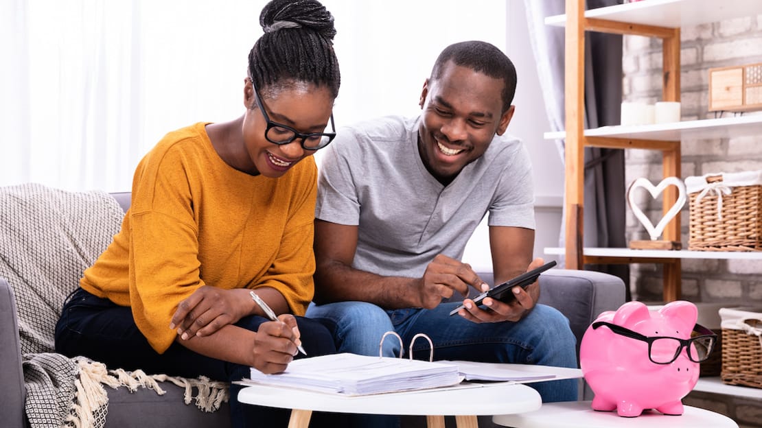 Couple discussing budgeting on a couch