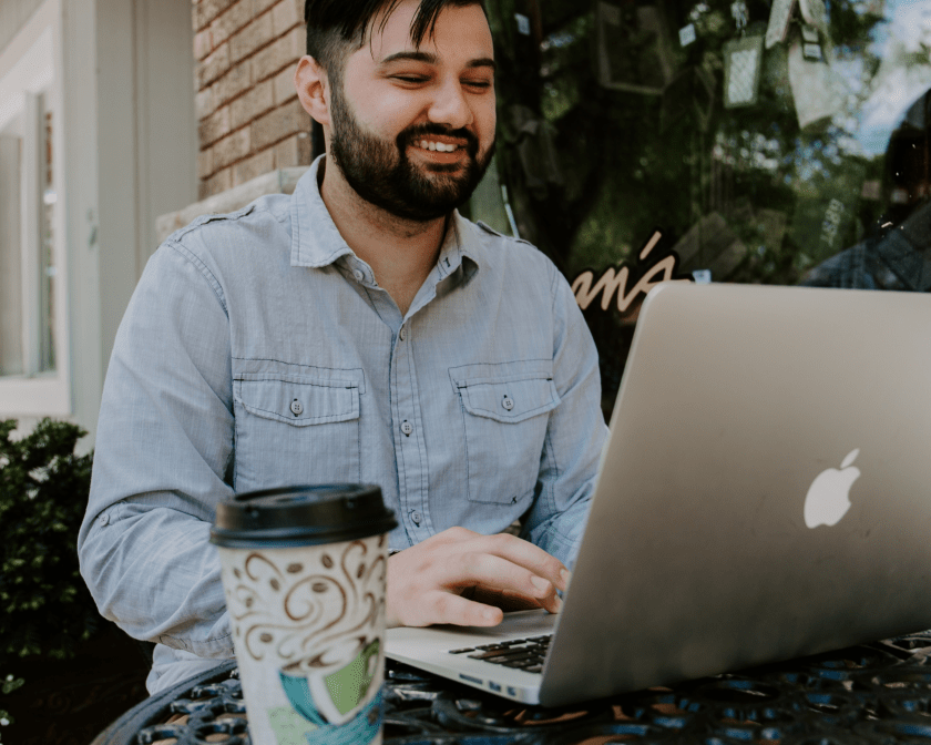 man working on a laptop at a cafe