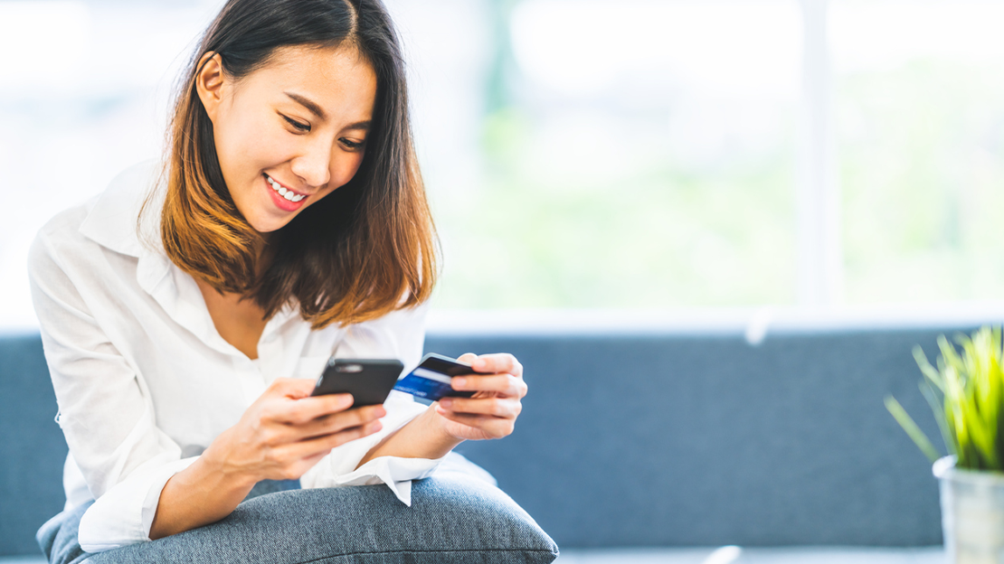 woman looking at credit card