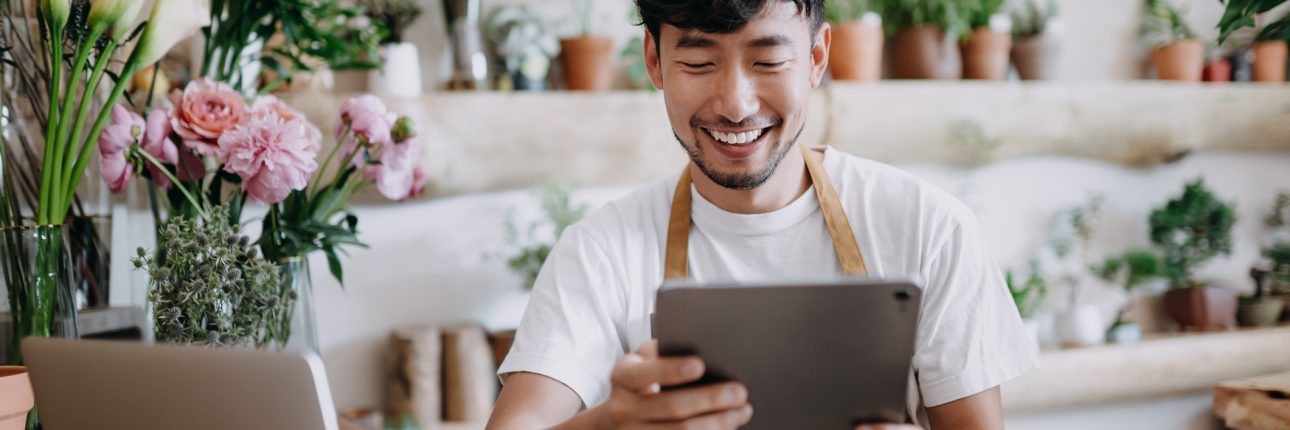 male florist looking at ipad