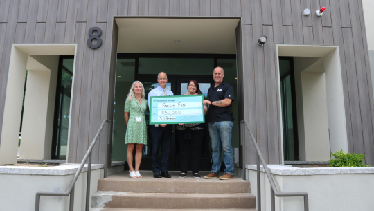 Kennebunk Savings President and CEO Brad Paige presents a check to the Families First nonprofit organization.