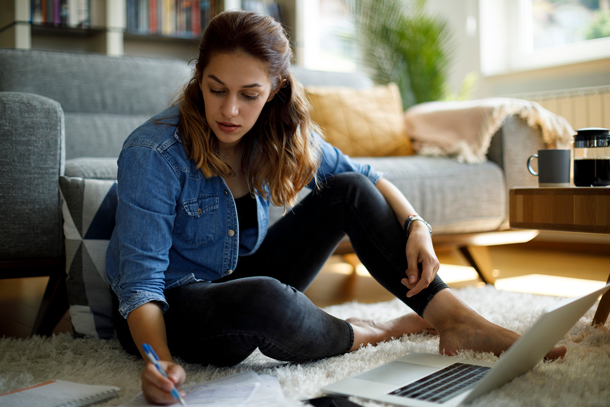 young woman paying student loan in her apartment