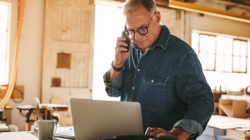 business man on computer in his shop